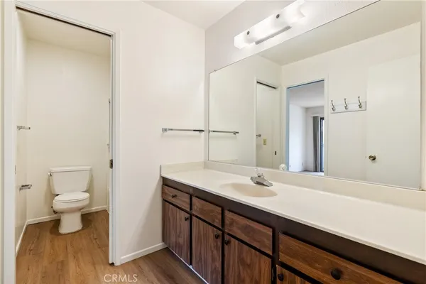 a bathroom with a sink a toilet and a mirror