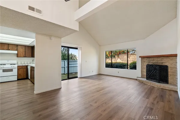 a view of a livingroom with a fireplace and wooden floor