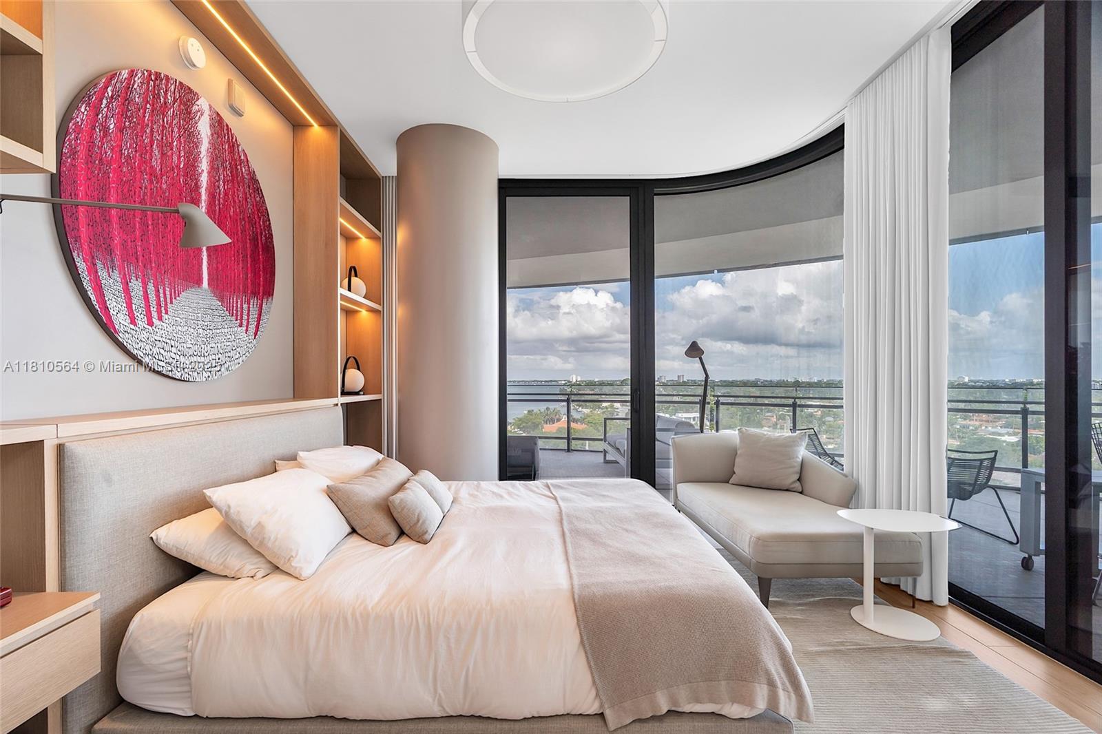 8701 Collins Avenue, Unit 905 Miami Beach, FL 33154 - Photo 3 of 80 a bedroom with a bed and glass window