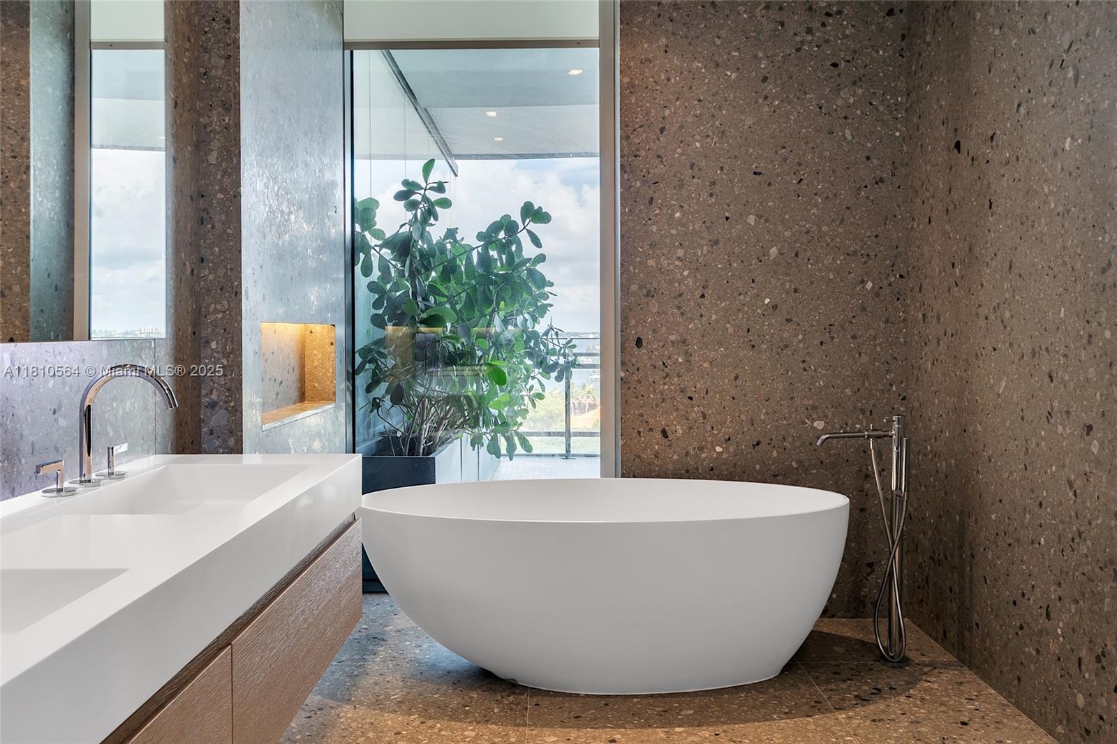 8701 Collins Avenue, Unit 905 Miami Beach, FL 33154 - Photo 34 of 80 a white bath tub sitting in a bathroom