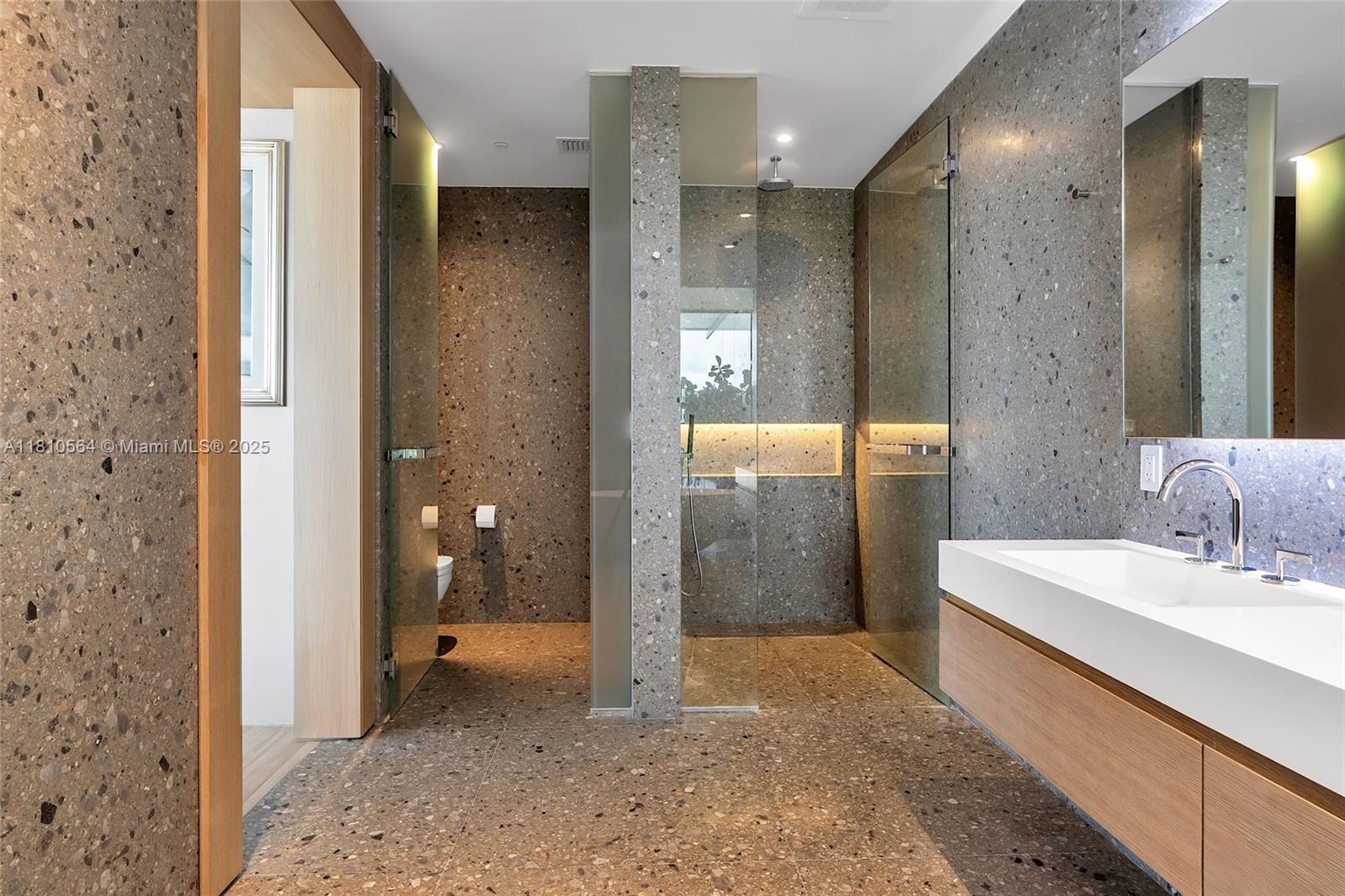 8701 Collins Avenue, Unit 905 Miami Beach, FL 33154 - Photo 35 of 80 a bathroom with a sink and a mirror