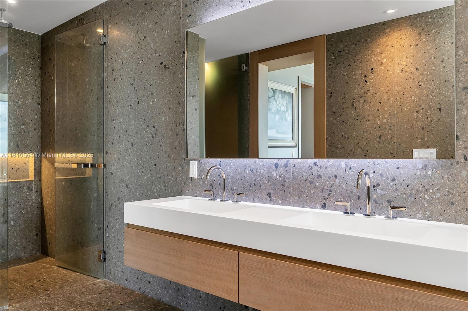 8701 Collins Avenue, Unit 905 Miami Beach, FL 33154 - Photo 36 of 80 a bathroom with a sink and a mirror