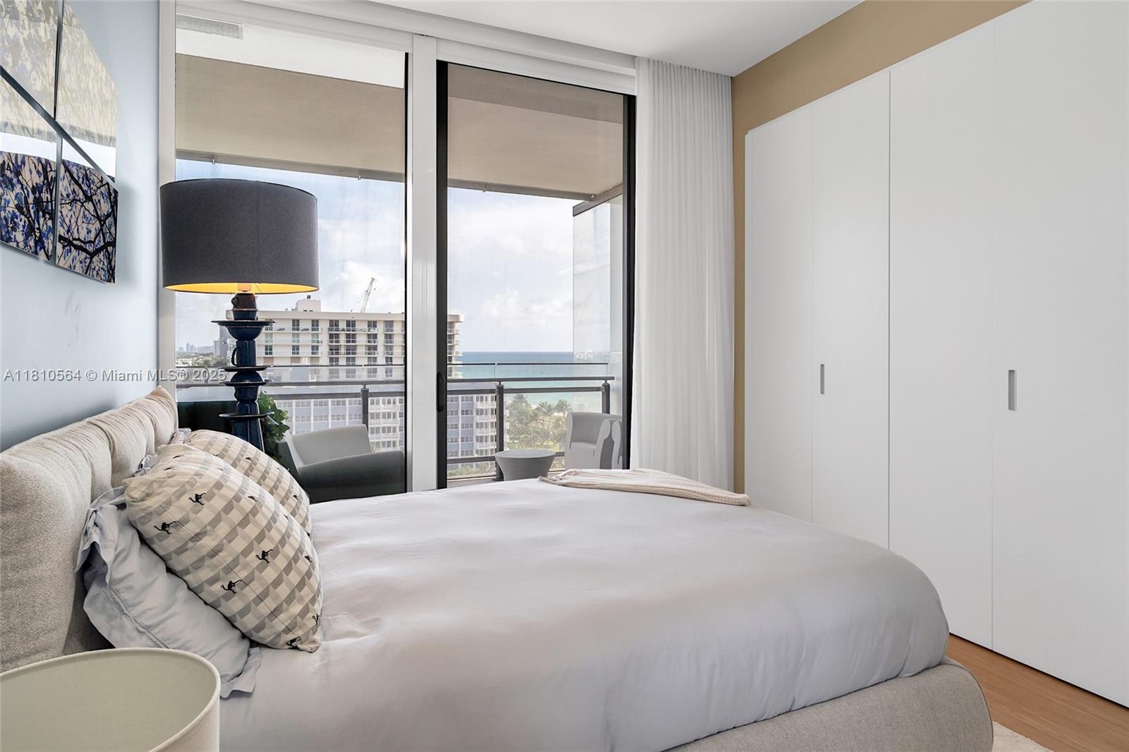 8701 Collins Avenue, Unit 905 Miami Beach, FL 33154 - Photo 38 of 80 a bedroom with a bed and a large window