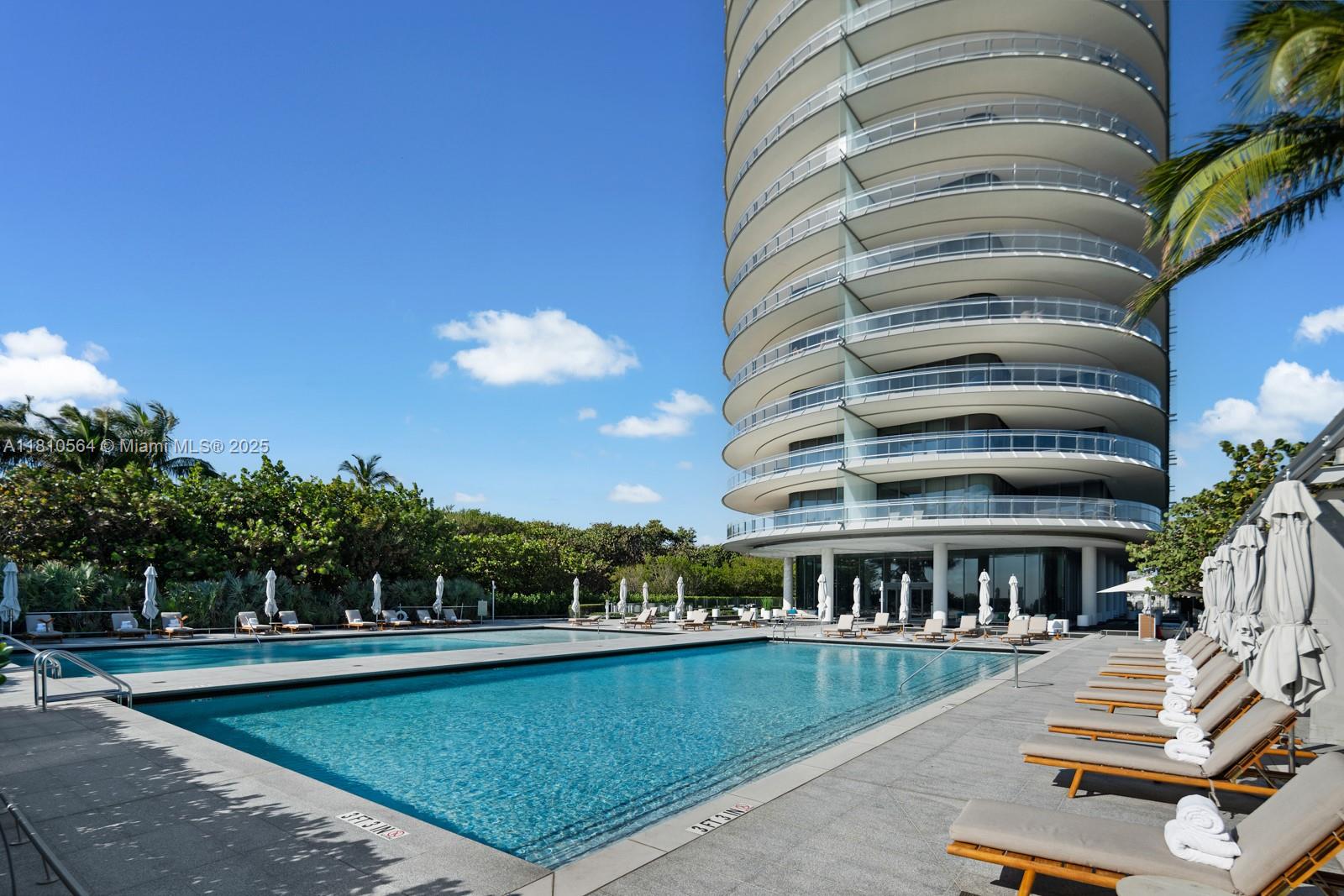 8701 Collins Avenue, Unit 905 Miami Beach, FL 33154 - Photo 48 of 80 a view of a swimming pool with outdoor seating and plants