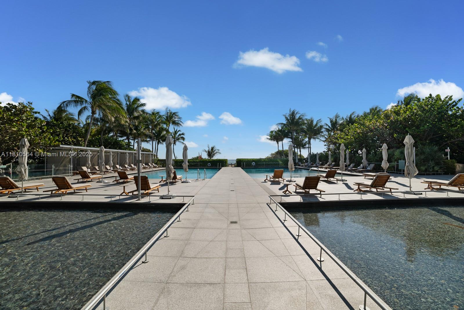 8701 Collins Avenue, Unit 905 Miami Beach, FL 33154 - Photo 49 of 80 a view of swimming pool with outdoor seating and city view