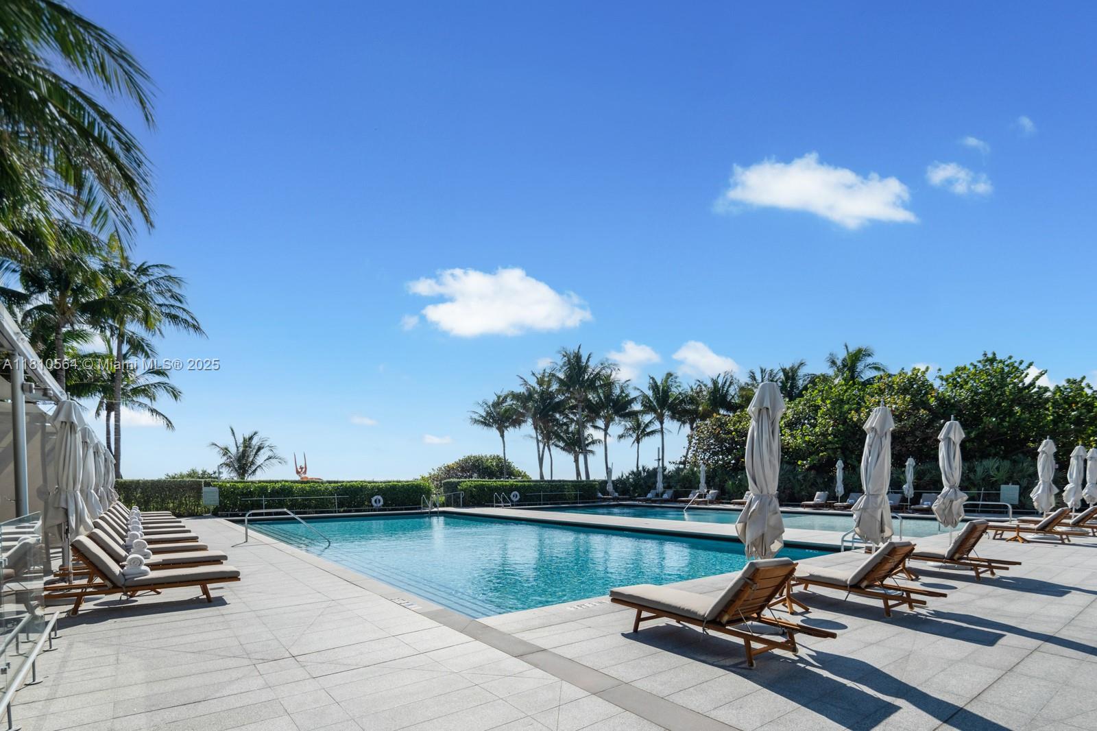 8701 Collins Avenue, Unit 905 Miami Beach, FL 33154 - Photo 53 of 80 a view of a lake with a bench and lake view