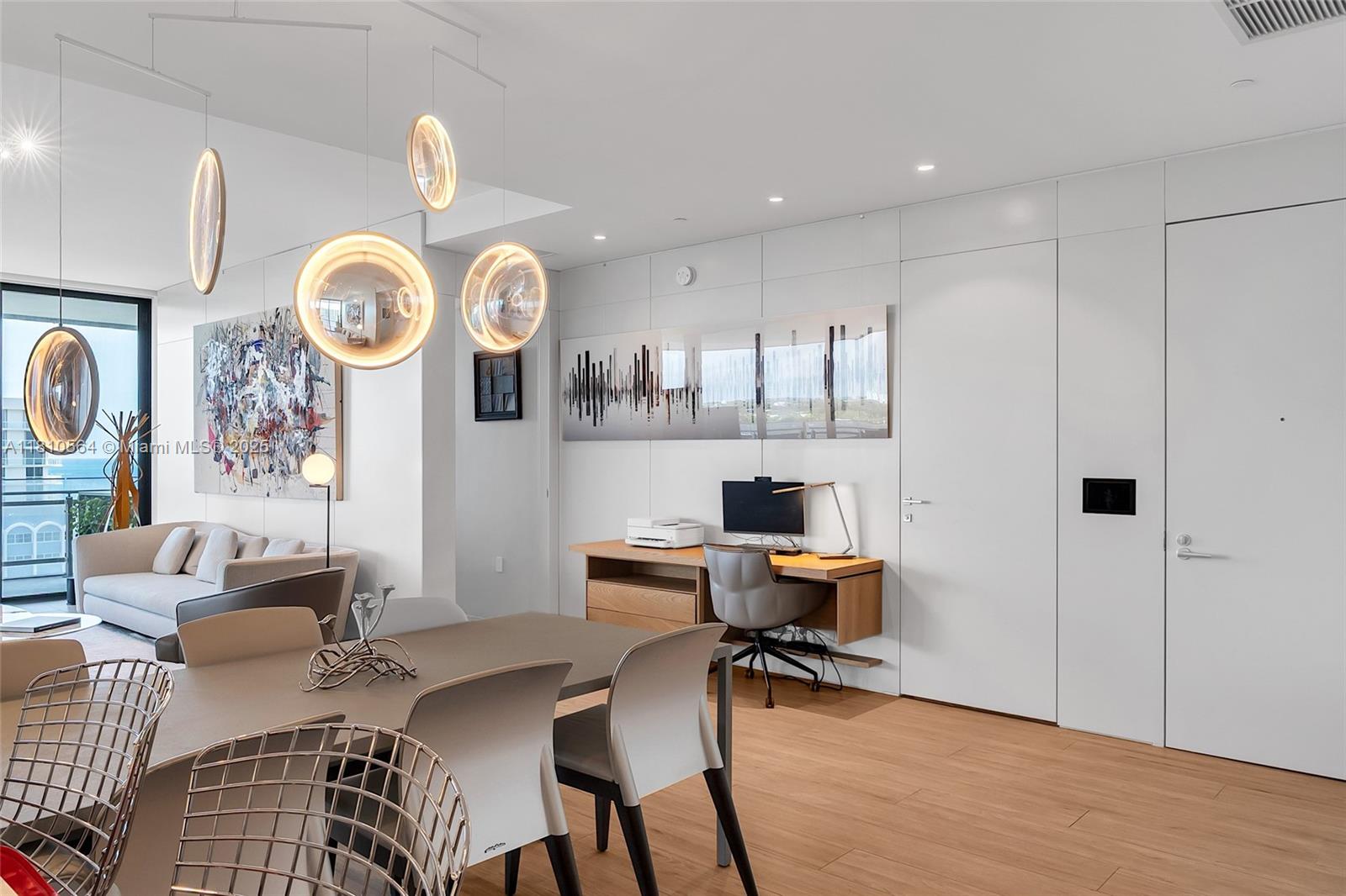 8701 Collins Avenue, Unit 905 Miami Beach, FL 33154 - Photo 10 of 80 a view of a dining room with furniture and a clock