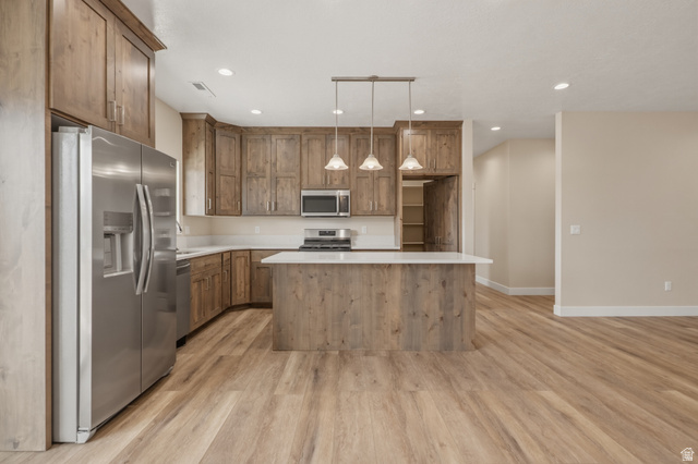 157 West 100 South Joseph, UT 84739 - Photo 9 of 30 Kitchen with stainless steel appliances, pendant lighting, light wood finished floors, wood finish cabinets, and a center island