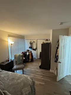 a bedroom with furniture and a closet