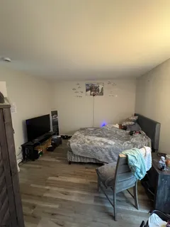 a bedroom with a bed and a tv on table