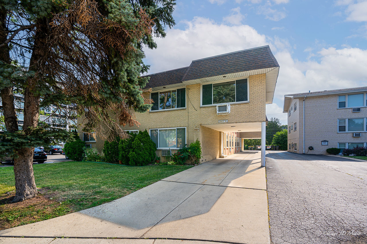 5949 North Odell Avenue, Unit 2E Chicago, IL 60631 - Photo 1 of 12 a front view of house with yard and green space
