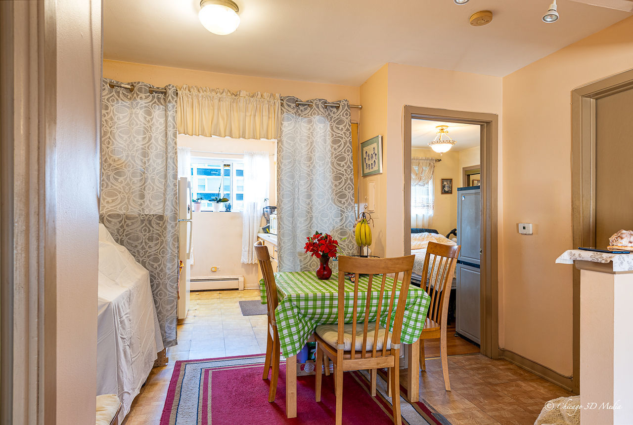 5949 North Odell Avenue, Unit 2E Chicago, IL 60631 - Photo 5 of 12 a view of a dining room with furniture window and wooden floor