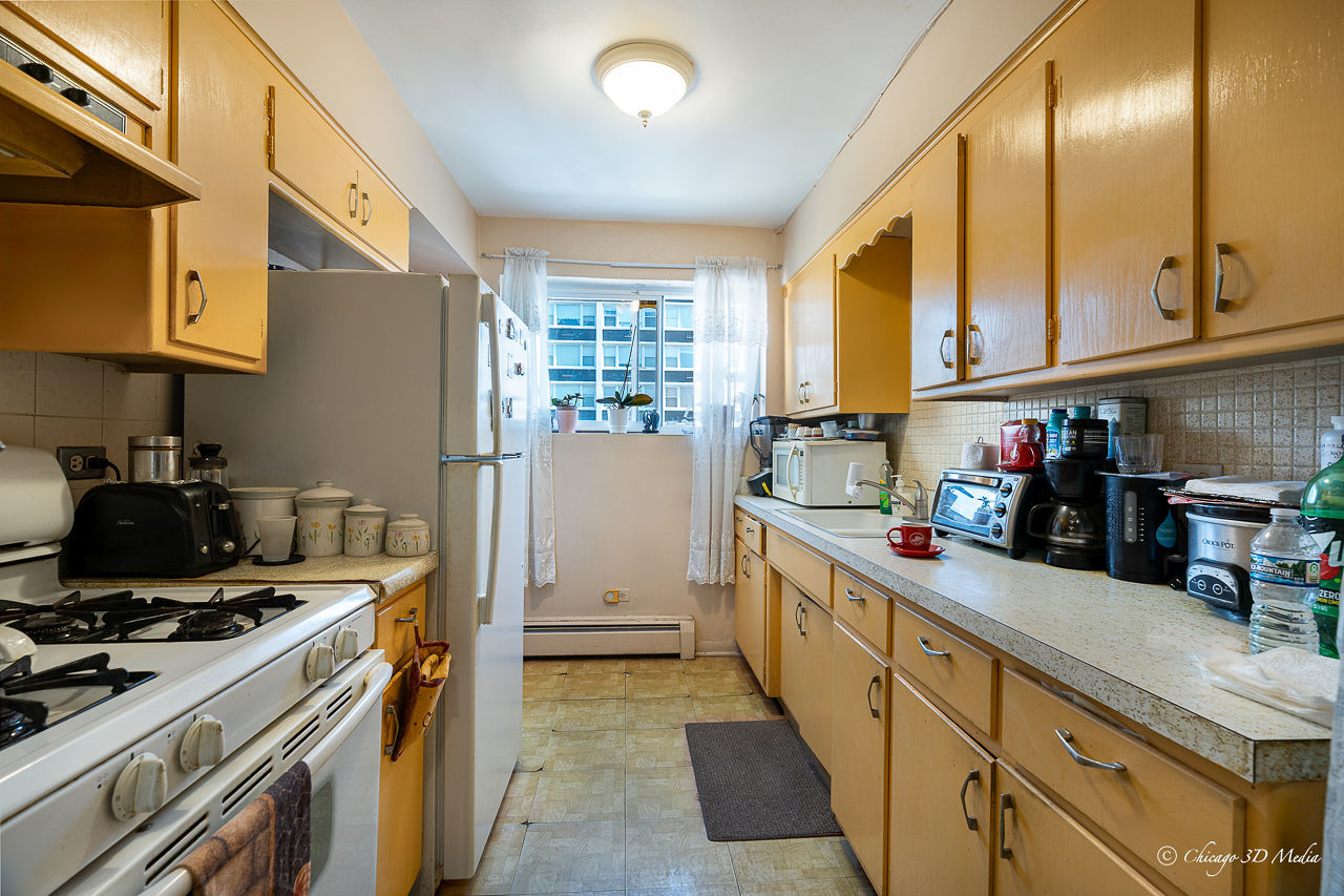 5949 North Odell Avenue, Unit 2E Chicago, IL 60631 - Photo 6 of 12 a kitchen with a sink a stove and a refrigerator