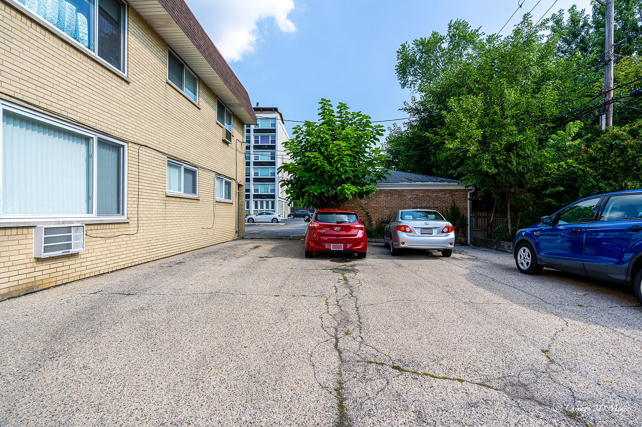 5949 North Odell Avenue, Unit 2E Chicago, IL 60631 - Photo 10 of 12 a car parked in front of a house