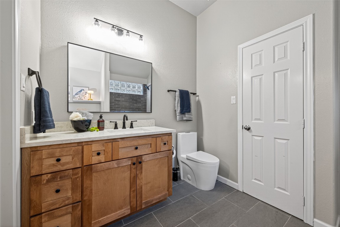 2910 Crescent Bend Road Spring, TX 77388 - Photo 14 of 35 Wow—your remodeled primary bath is a true retreat, complete with a large soaking tub and new tile surround, tile floors, a maple wood and stone vanity, sleek mirror, fresh paint, and a modern, energy-efficient top-flush toilet.