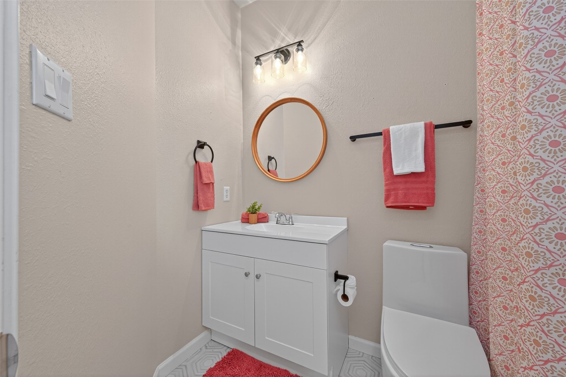 2910 Crescent Bend Road Spring, TX 77388 - Photo 19 of 35 Second bath is charming and fresh with a new vanity, wood-accent mirror, stylish hex tile flooring, and a sleek, energy-efficient one-piece toilet.