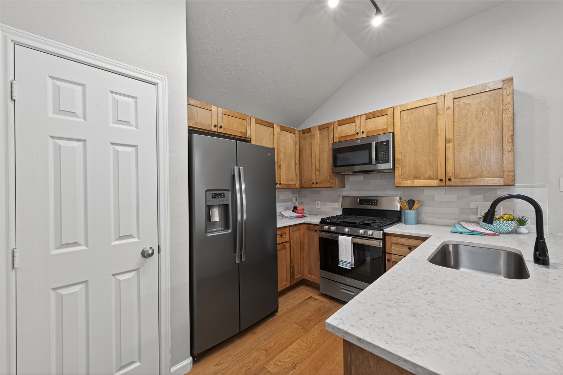 2910 Crescent Bend Road Spring, TX 77388 - Photo 4 of 35 This stunning kitchen is ready for you to enjoy, complete with 3cm quartz countertops, a handcrafted Zellige tile backsplash, elegant maple cabinets, and a full-size stainless steel refrigerator.