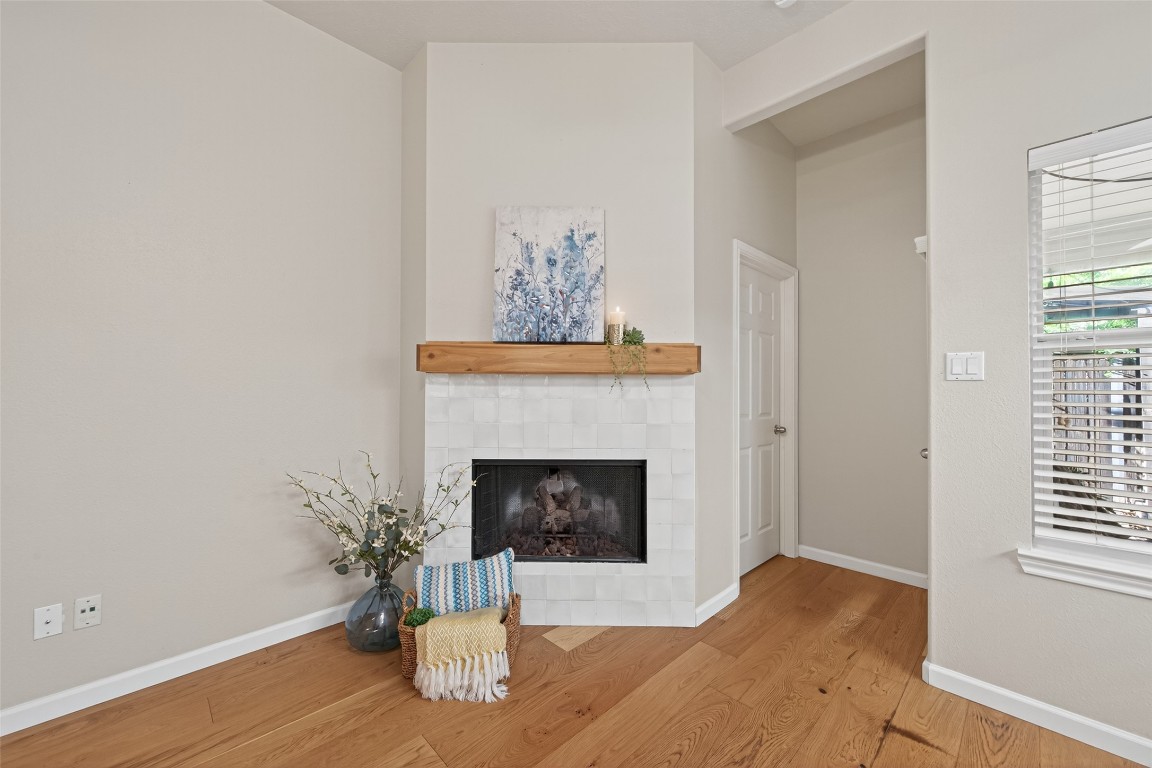 2910 Crescent Bend Road Spring, TX 77388 - Photo 8 of 35 Refined fireplace refresh with updated tile and a custom-crafted cedar mantle that coordinates beautifully with your new floors.