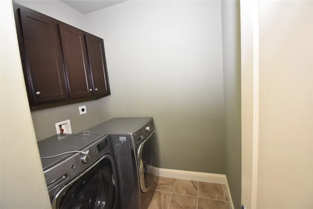 a view of storage and utility room with washer and dryer