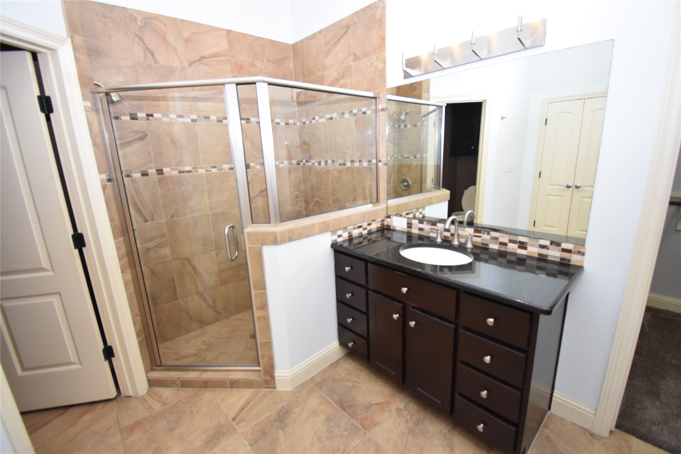 12105 Terraza Circle, Unit 67 Austin, TX 78726 - Photo 12 of 39 a bathroom with a shower sink and mirror