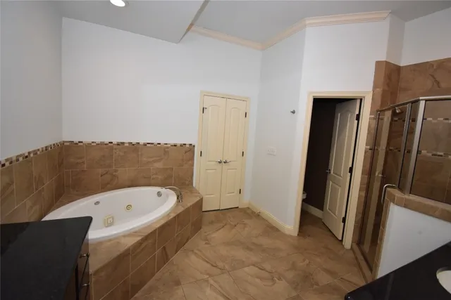 a bathroom with a tub and a shower