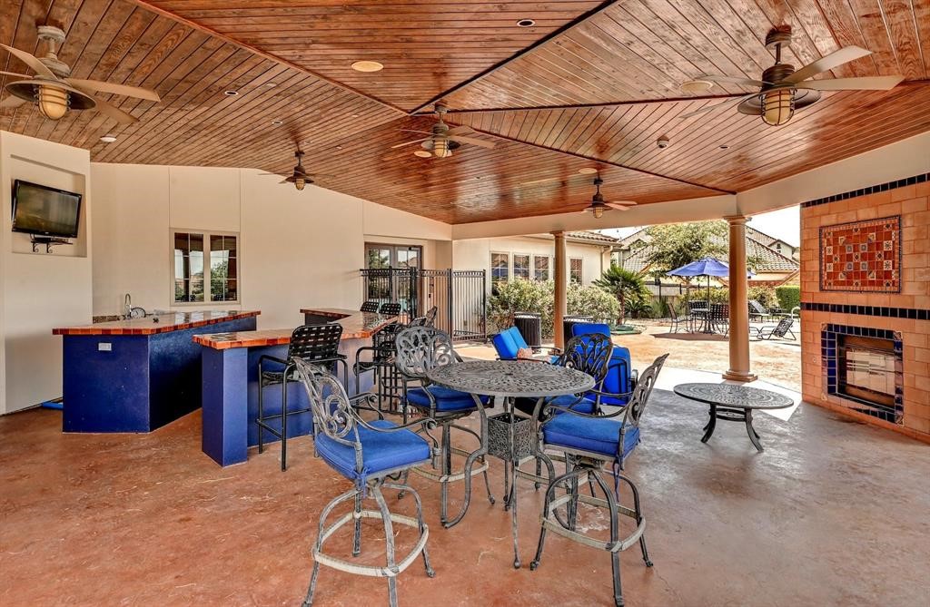 12105 Terraza Circle, Unit 67 Austin, TX 78726 - Photo 17 of 39 a outdoor space with lots of tables a chairs and a fireplace
