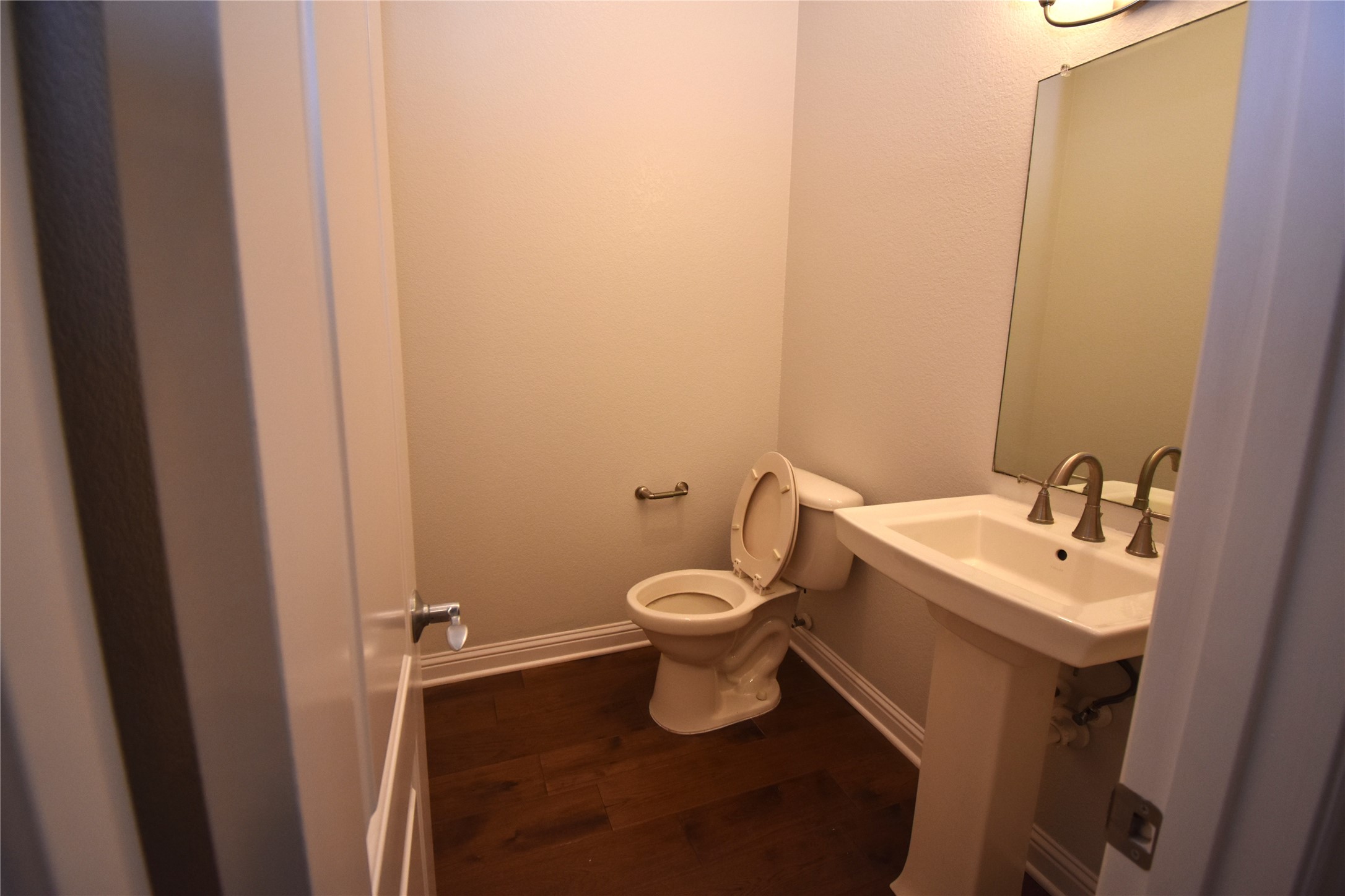 12105 Terraza Circle, Unit 67 Austin, TX 78726 - Photo 20 of 39 a bathroom with a toilet sink and mirror