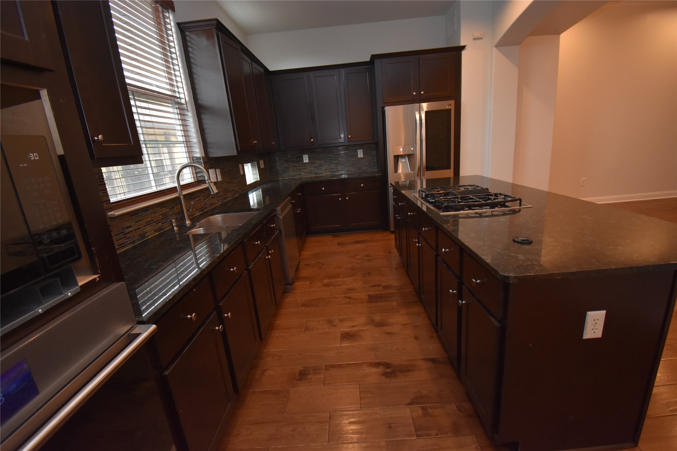 12105 Terraza Circle, Unit 67 Austin, TX 78726 - Photo 22 of 39 a kitchen with granite countertop sink stove and refrigerator