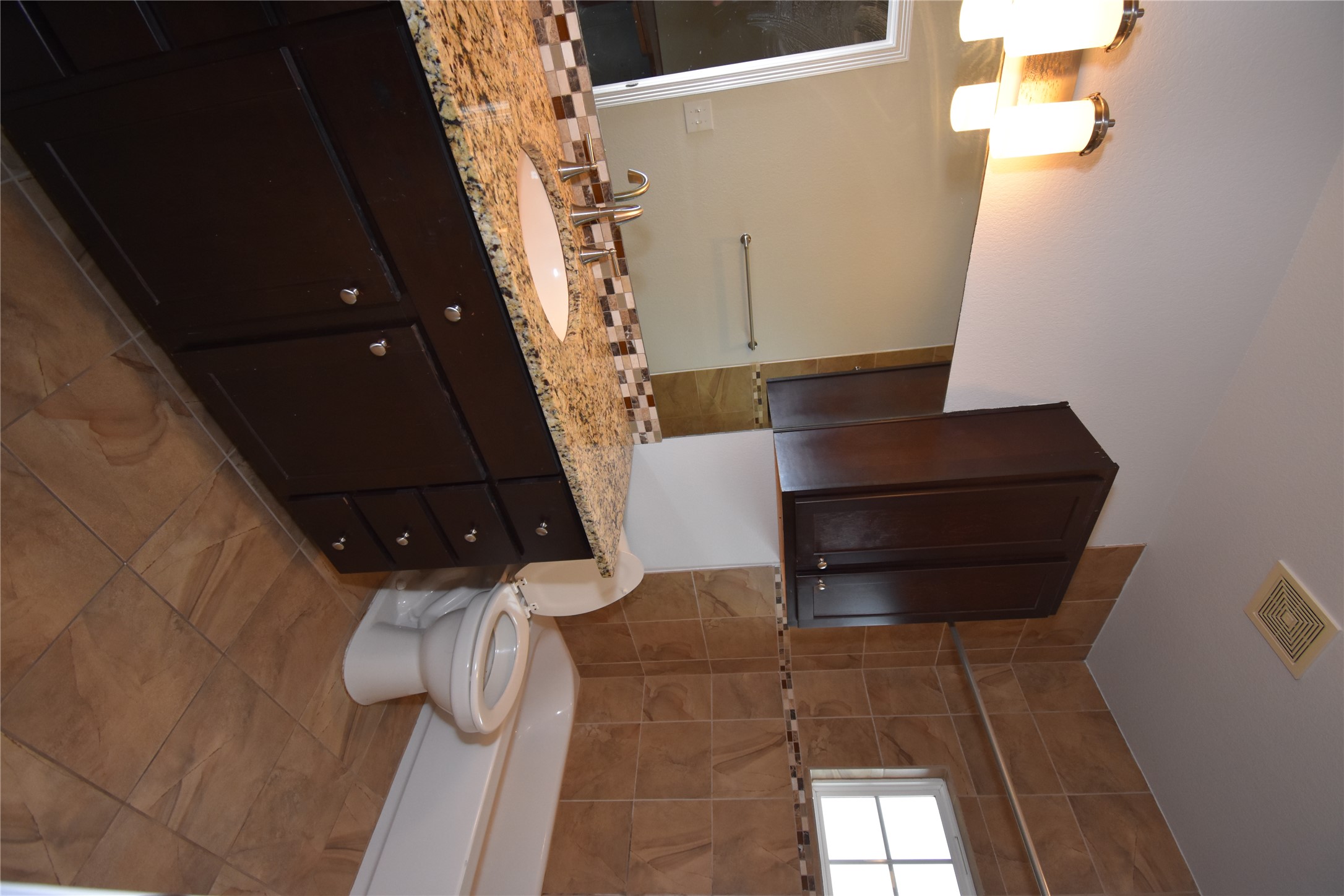 12105 Terraza Circle, Unit 67 Austin, TX 78726 - Photo 33 of 39 a bathroom with a granite countertop toilet sink and mirror
