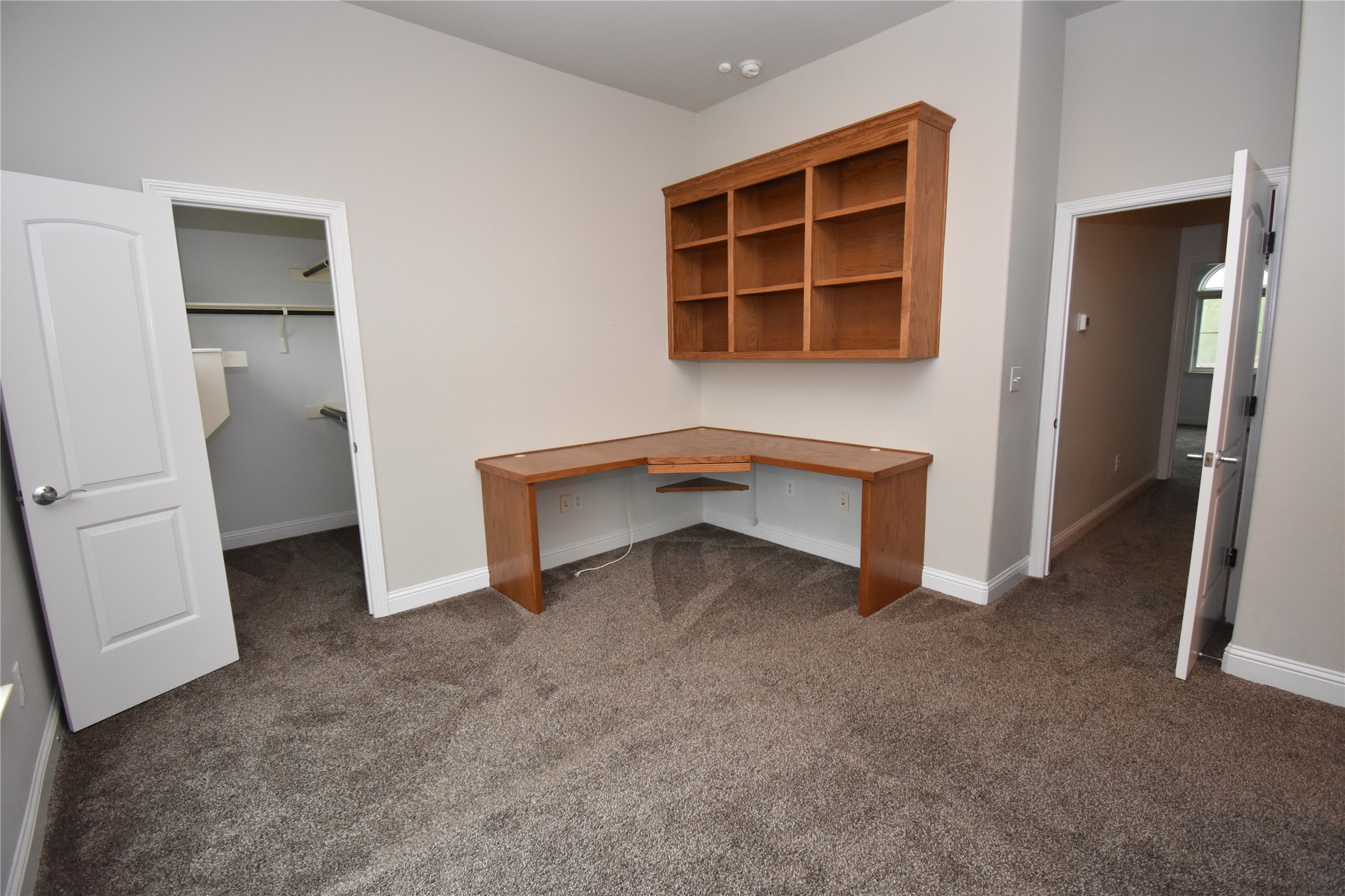 12105 Terraza Circle, Unit 67 Austin, TX 78726 - Photo 35 of 39 an empty room with a fireplace and cabinet