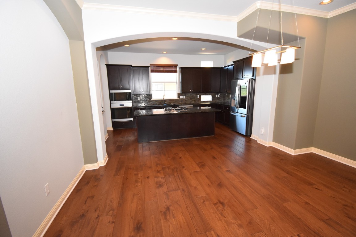 12105 Terraza Circle, Unit 67 Austin, TX 78726 - Photo 4 of 30 a view of a living room with kitchen appliances and wooden floor