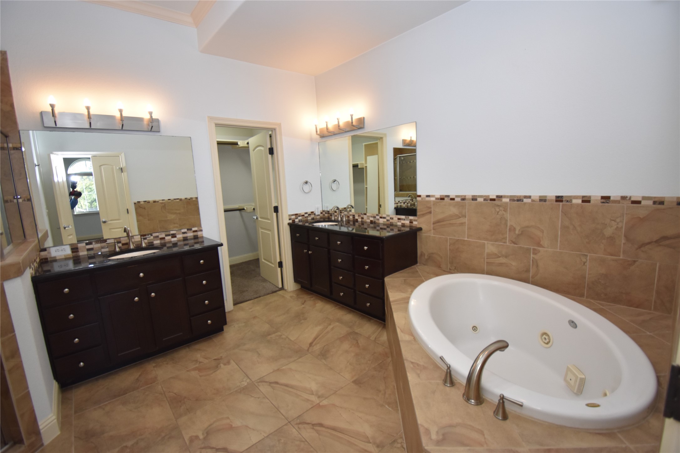 12105 Terraza Circle, Unit 67 Austin, TX 78726 - Photo 9 of 39 a spacious bathroom with a tub sink and mirror