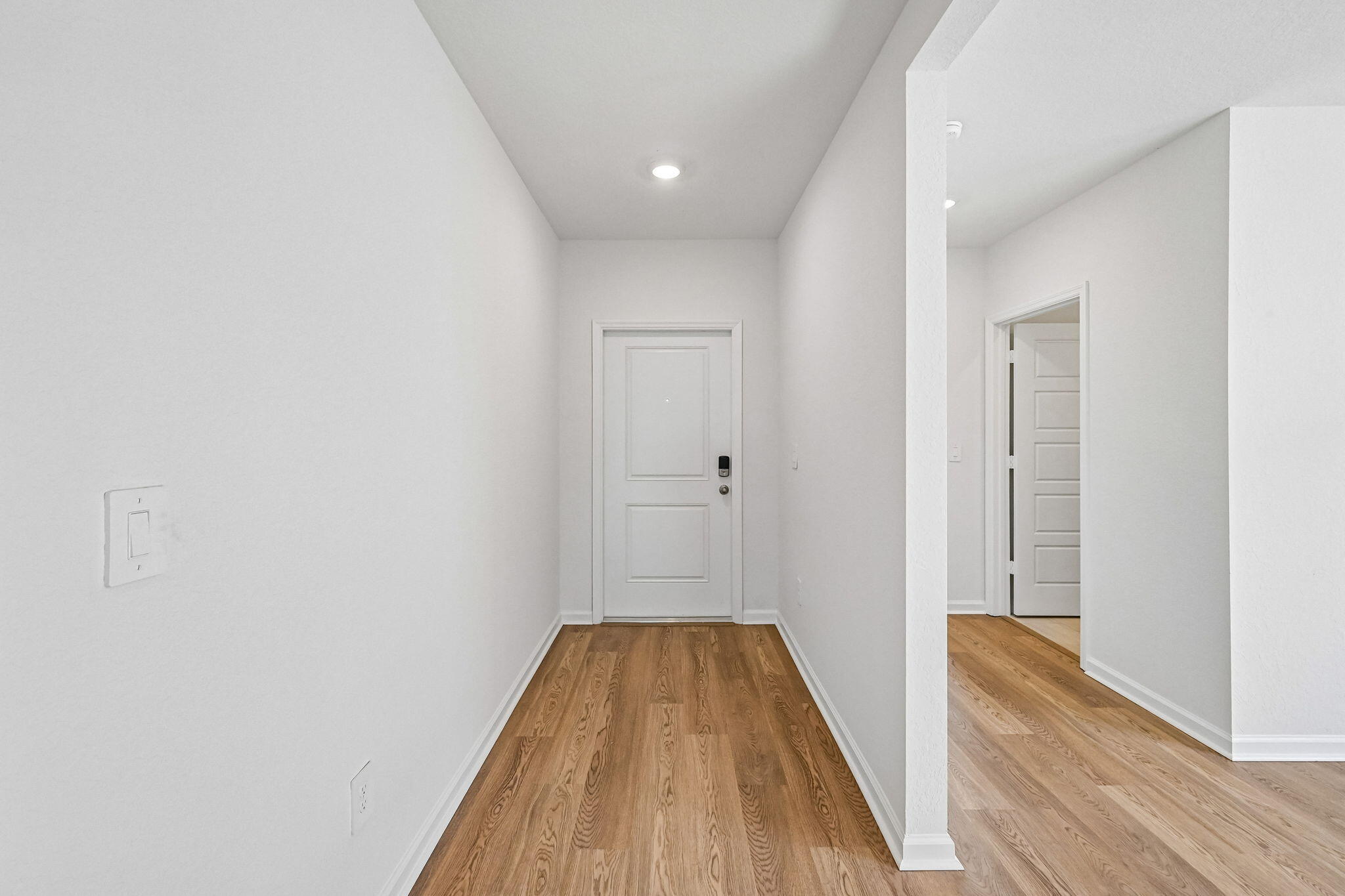 14503 Southwest New Dawn Road Indiantown, FL 34956 - Photo 14 of 42 a view of a hallway with wooden floor and a bathroom