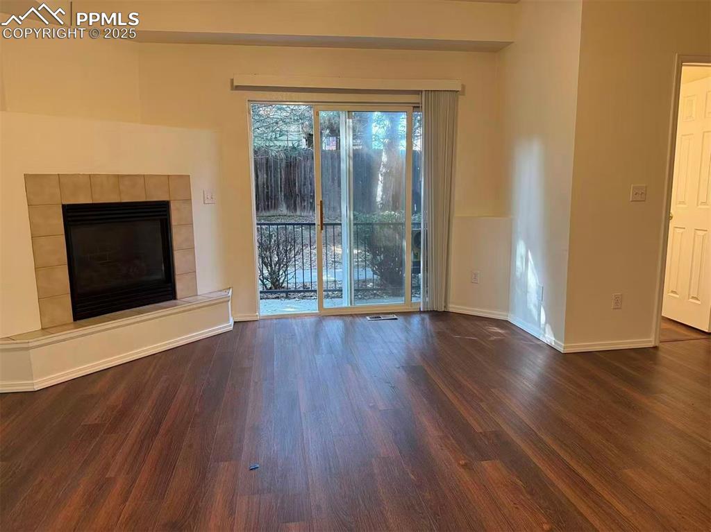 2095 Legacy Ridge View, Unit 102 Colorado Springs, CO 80910 - Photo 3 of 13 a view of an empty room with wooden floor and a window