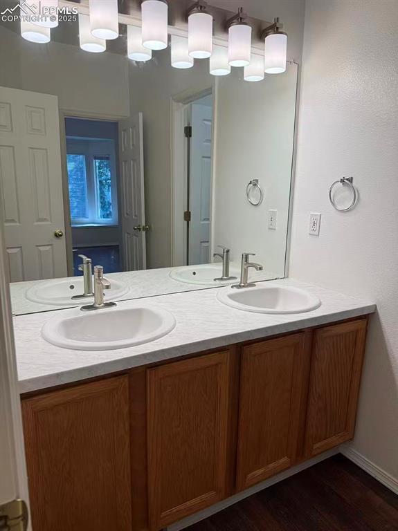 2095 Legacy Ridge View, Unit 102 Colorado Springs, CO 80910 - Photo 5 of 13 a bathroom with a sink double vanity and a mirror