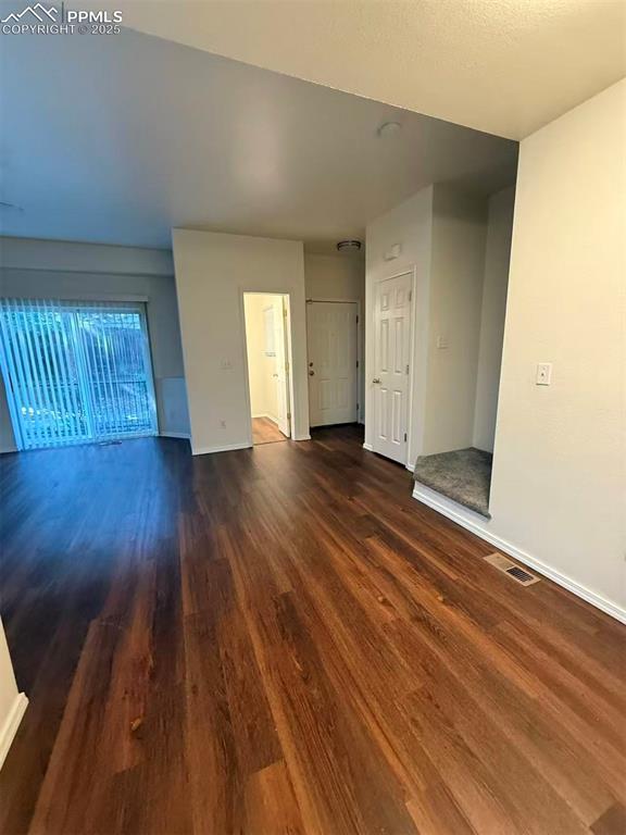 2095 Legacy Ridge View, Unit 102 Colorado Springs, CO 80910 - Photo 7 of 13 an empty room with wooden floor and windows