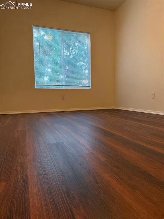 2095 Legacy Ridge View, Unit 102 Colorado Springs, CO 80910 - Photo 8 of 13 an empty room with wooden floor and windows