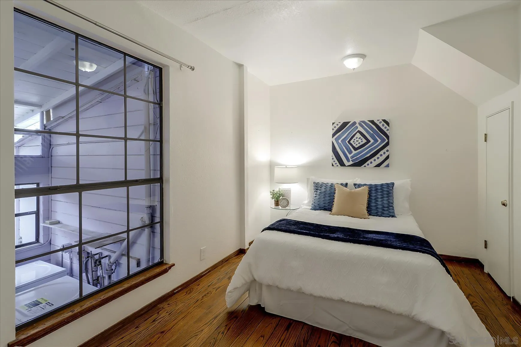 1521 D Street Hayward, CA 94541 - Photo 24 of 39 a bedroom with a bed and painting on the wall