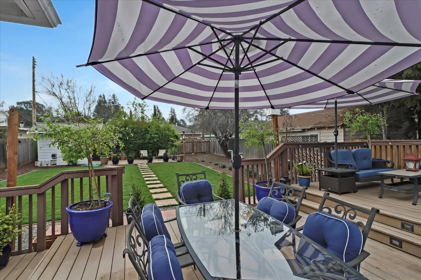 1521 D Street Hayward, CA 94541 - Photo 34 of 39 a patio with wooden floor a yard a table and chairs