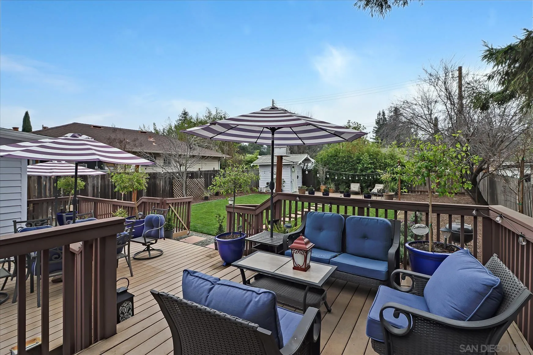1521 D Street Hayward, CA 94541 - Photo 35 of 39 a view of a patio with couches chairs under an umbrella with a small yard