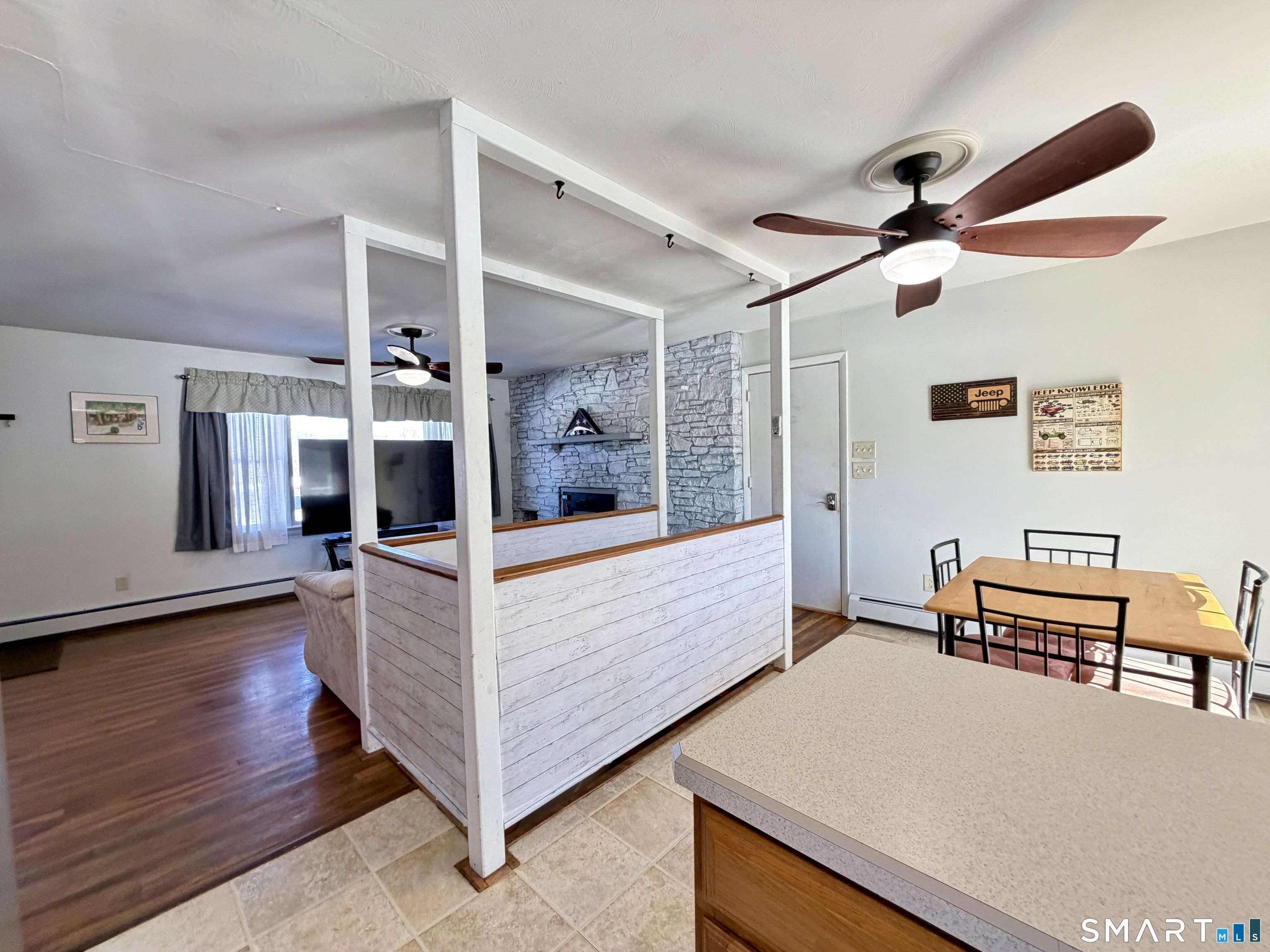 208 Gooseneck Hill Road Canterbury, CT 06331 - Photo 11 of 34 a view of an empty room with furniture wooden floor and a ceiling fan