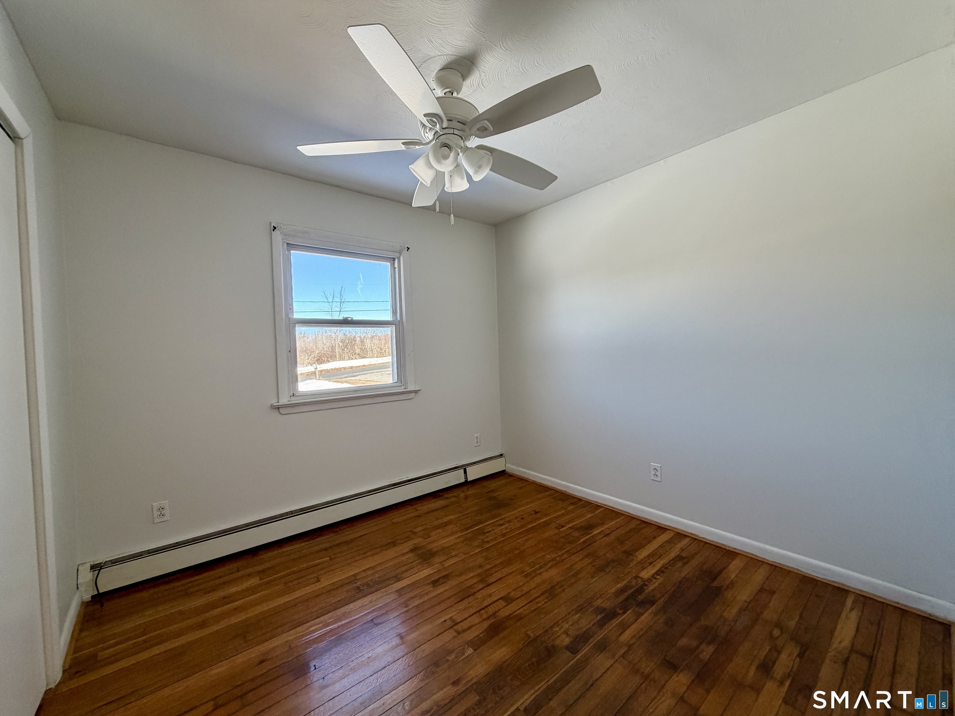 208 Gooseneck Hill Road Canterbury, CT 06331 - Photo 15 of 34 a view of a room with wooden floor and a ceiling fan
