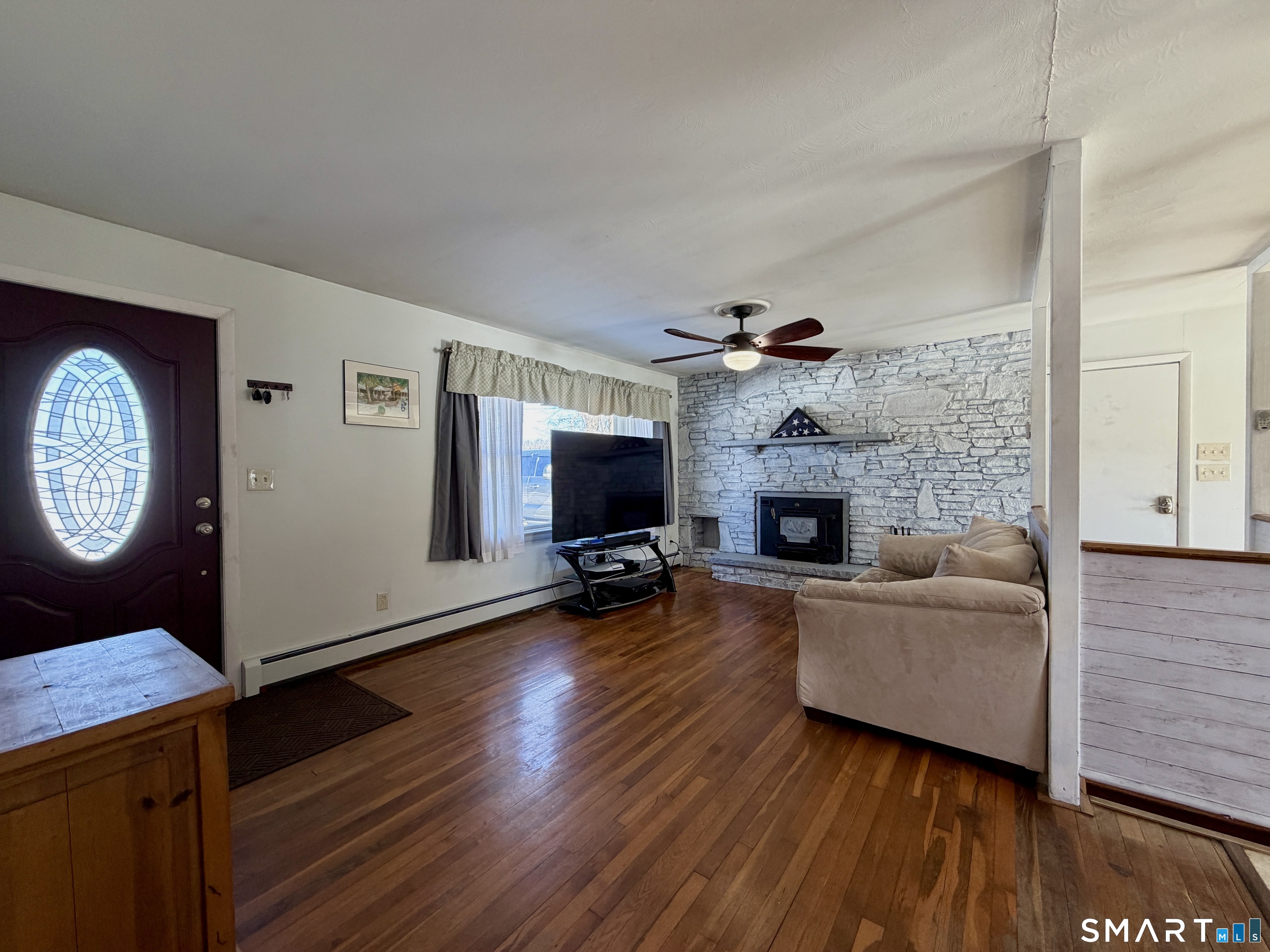 208 Gooseneck Hill Road Canterbury, CT 06331 - Photo 7 of 34 a living room with furniture and a fireplace