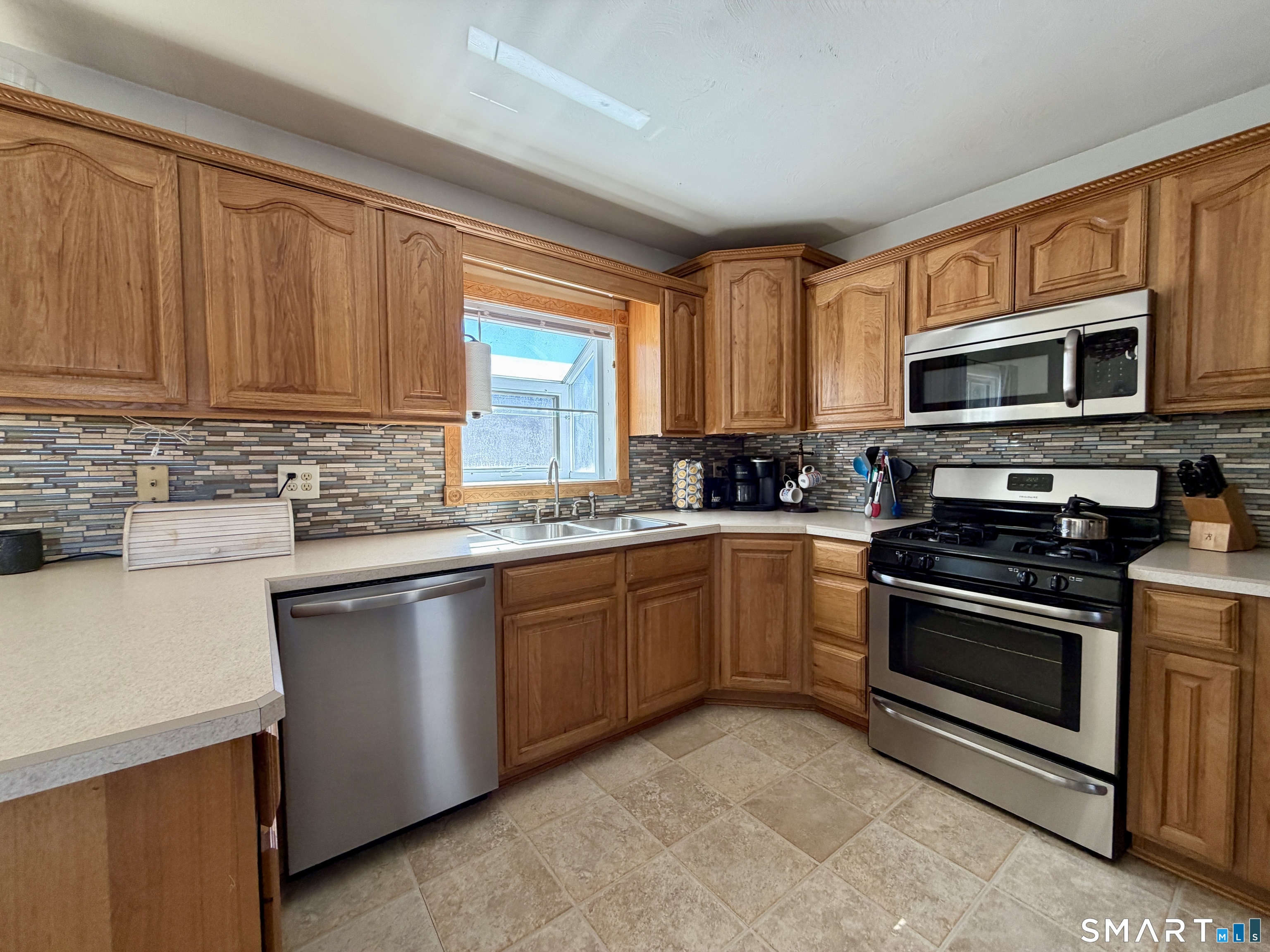 208 Gooseneck Hill Road Canterbury, CT 06331 - Photo 9 of 34 a kitchen with stainless steel appliances granite countertop a stove sink microwave and window
