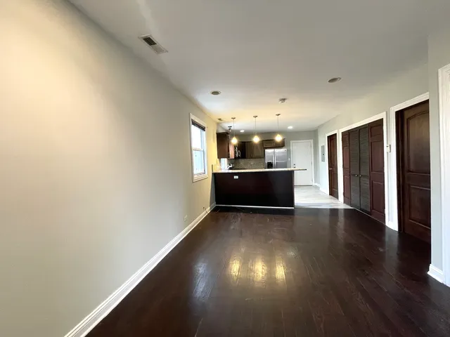 a view of a kitchen with a sink and a refrigerator