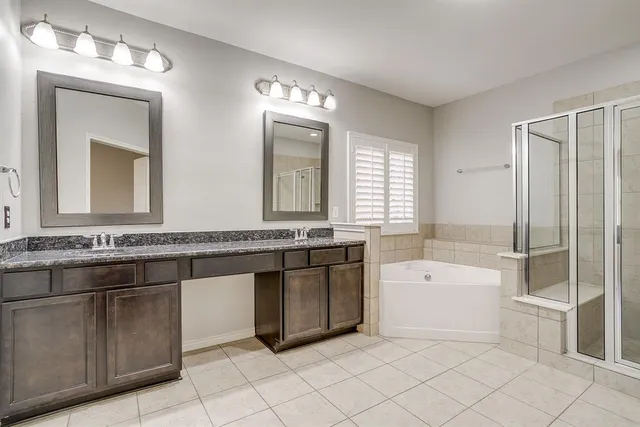 a bathroom with a tub sink and mirror