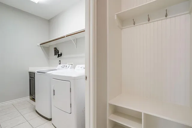 a utility room with cabinets washer and dryer