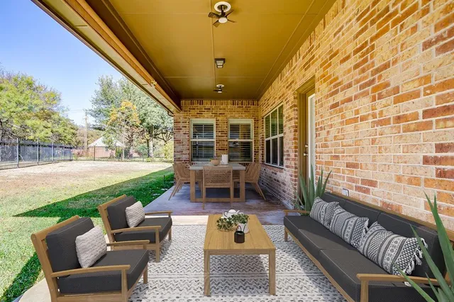 a balcony with patio furniture and garden