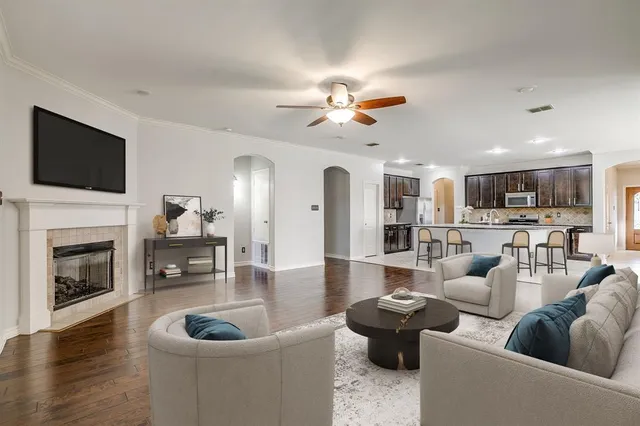 a living room with furniture a fireplace and a flat screen tv