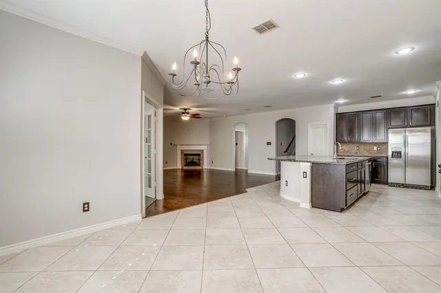 a large kitchen with kitchen island a sink stainless steel appliances and cabinets